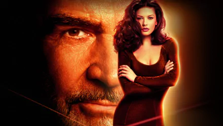 HD PC desktop wallpaper from the movie Entrapment, showing an intense close-up of a man's face beside a confident woman in a dark dress against a warm, glowing background.