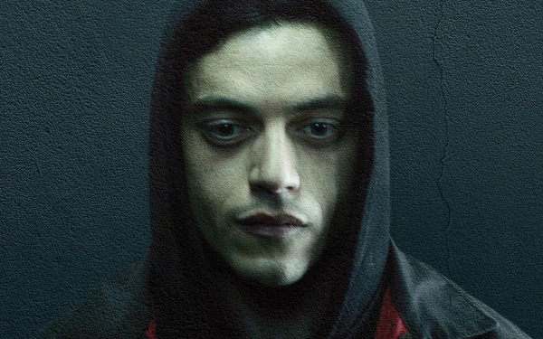 HD PC wallpaper: close-up of a hooded, brooding man against a textured teal wall — moody portrait from the TV show Mr. Robot.