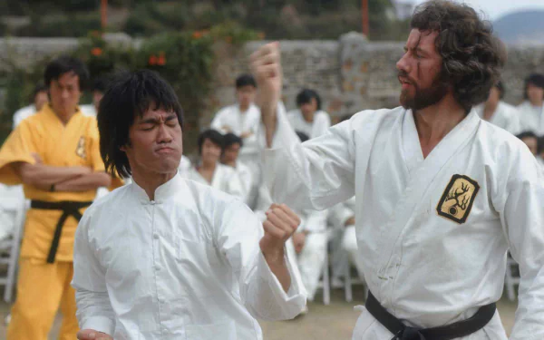 HD PC desktop wallpaper from the movie Enter the Dragon: two martial artists in white gis spar in an outdoor training courtyard while others watch.