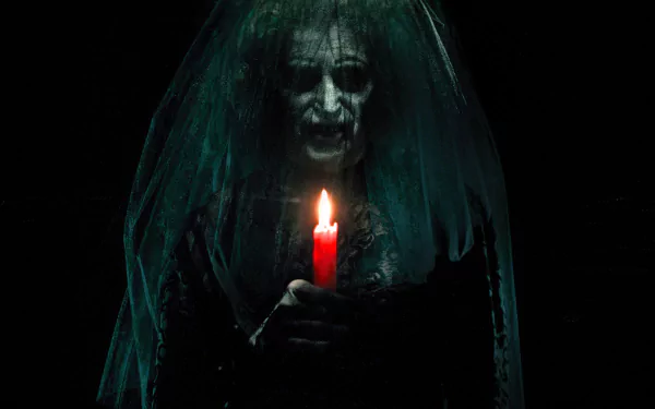 HD PC desktop wallpaper/background from the movie Insidious: a veiled, pale-faced specter grips a glowing red candle in darkness, its menacing grin and shadowy veil creating an eerie atmosphere.