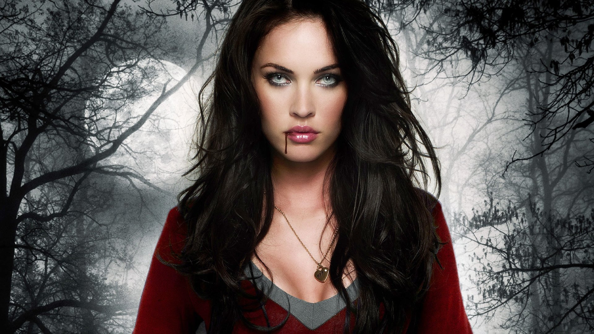 HD desktop wallpaper featuring Megan Fox as a vampire from the movie Jennifer's Body, set against a dark, eerie forest background.