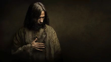 HD PC desktop wallpaper: somber cinematic portrayal of Jesus from the movie Killing Jesus, bowed head with hand over his chest against a dark, textured background.