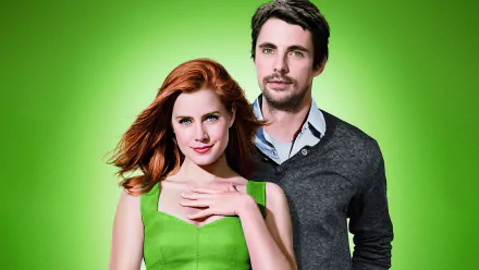 HD PC desktop wallpaper featuring Amy Adams and a male co-star from the movie Leap Year against a vibrant green background.