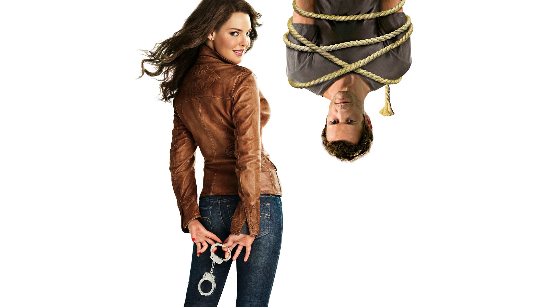 HD movie wallpaper for One for the Money: a woman in a brown leather jacket holding handcuffs looks back while a man hangs upside down, bound with rope.