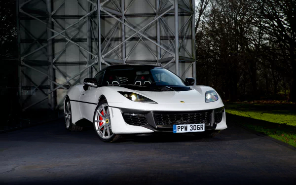 White Lotus Evora supercar parked outdoors, showcased in sharp 4K Ultra HD detail against a geometric metal backdrop and natural surroundings.
