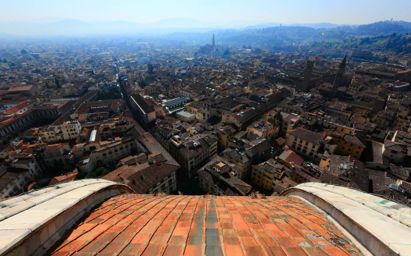A panoramic cityscape of Florence, Italy, showcasing historic buildings and rooftops under clear skies, captured in high definition for a desktop wallpaper.