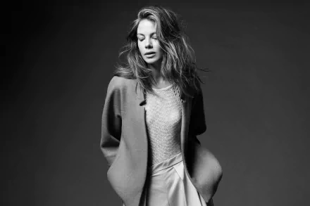 Black and white HD portrait of American actress Michelle Monaghan with tousled hair, wearing a blazer and skirt against a plain dark background.
