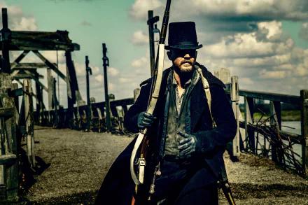 Tom Hardy as James Delaney in the TV show Taboo, dressed in period attire with a rifle, set against a rustic dock background in 4K Ultra HD.