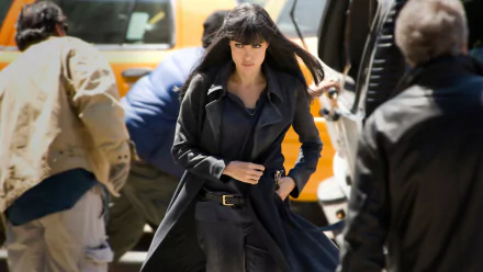 Angelina Jolie in character from the movie Salt, walking purposefully in a dark outfit, featured as an HD PC desktop wallpaper and background.