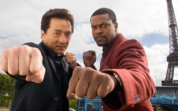 HD wallpaper featuring Chris Tucker and Jackie Chan striking action poses from the movie Rush Hour 3, with the Eiffel Tower in the background.