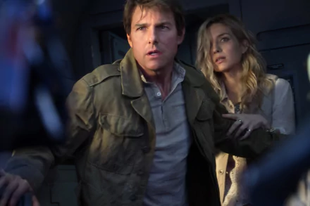 HD wallpaper featuring Annabelle Wallis and Tom Cruise in a tense scene from the movie The Mummy (2017). Both actors look intense and focused, highlighting the film's adventurous theme.