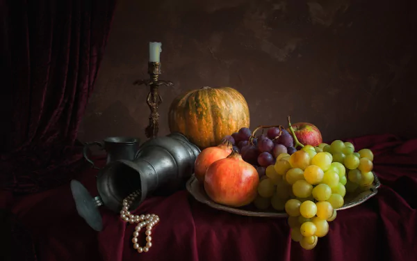 Still life HD wallpaper featuring grapes, a gourd, a candle, a cup, and a pitcher arranged on a dark velvet surface with classic photography lighting.