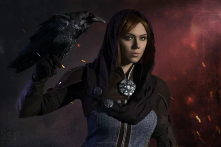 HD desktop wallpaper of a woman cosplaying Leliana from Dragon Age: Inquisition, holding a black raven against a dark, smoky background.