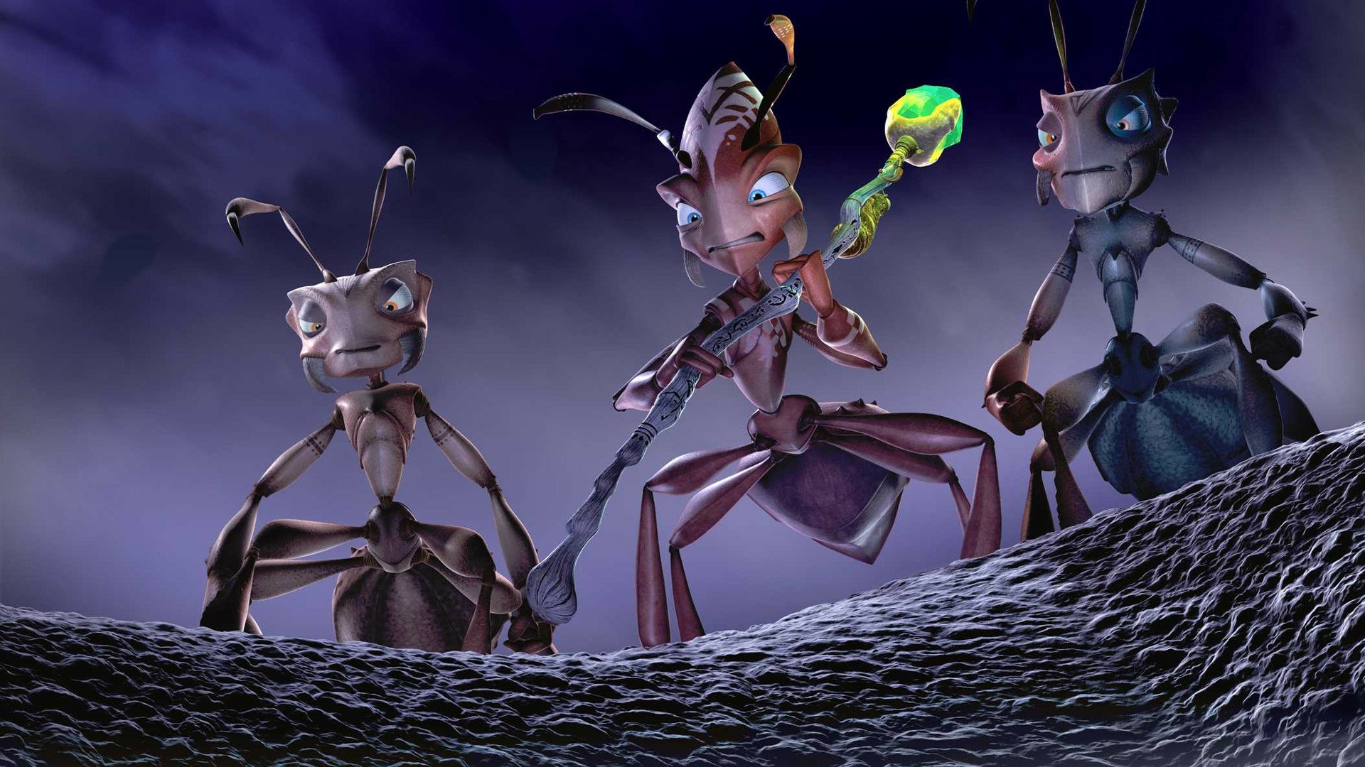 HD PC desktop wallpaper from the movie The Ant Bully: three animated ants on a rocky ridge beneath a moody purple sky, one holding a glowing green staff.