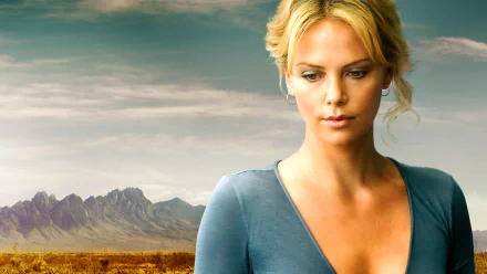 HD desktop wallpaper: cinematic close-up of a blonde woman before a wide mountain plain, moody tones evoking the movie The Burning Plain.
