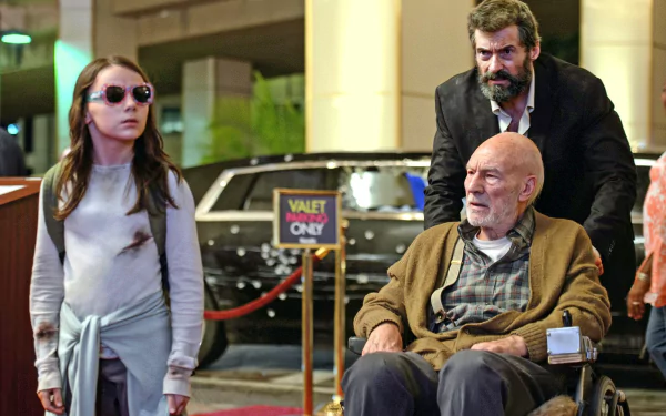 HD wallpaper featuring a scene from the movie Logan with Hugh Jackman as Logan, Patrick Stewart as Professor X in a wheelchair, and Dafne Keen as Laura Kinney (X-23).