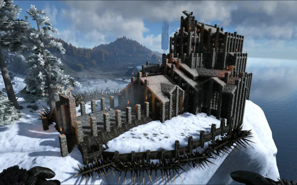 HD PC desktop wallpaper showcasing a fortress built on a snowy cliff in the video game Ark: Survival Evolved, with a dramatic mountainous and ocean backdrop.