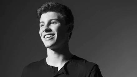 HD desktop wallpaper featuring a monochrome portrait of a smiling Shawn Mendes with a dark background.