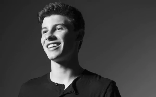 HD desktop wallpaper featuring a monochrome portrait of a smiling Shawn Mendes with a dark background.