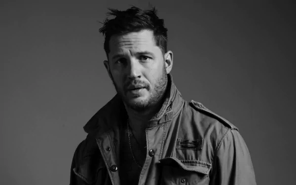 Black and white HD desktop wallpaper featuring English actor and celebrity Tom Hardy in a rugged jacket against a plain background.
