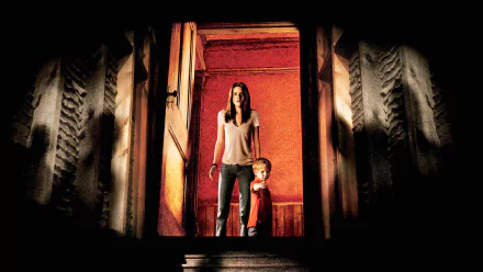 HD desktop wallpaper featuring Kristen Stewart from the movie The Messengers, standing with a young child in a dimly lit, eerie setting.