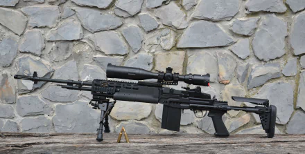 4K Ultra HD PC desktop wallpaper: man-made sniper rifle with scope and bipod resting against a stone wall, two brass cartridges on a wooden ledge.