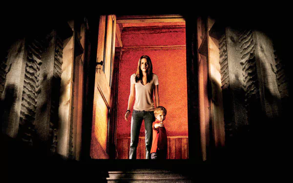 HD desktop wallpaper featuring Kristen Stewart from the movie The Messengers, standing with a young child in a dimly lit, eerie setting.