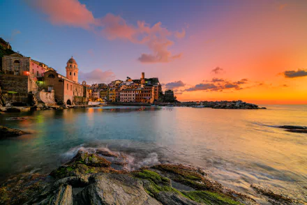 Sunset over the man-made harbor and colorful buildings of Vernazza in Cinque Terre, Italy, captured in stunning 4K Ultra HD detail.