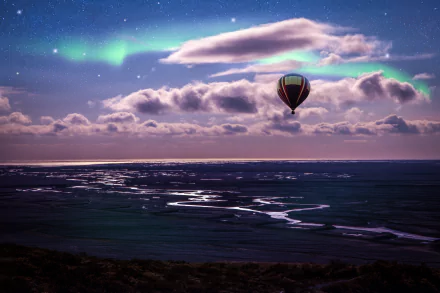 A hot air balloon floats over a vast ocean under a dramatic sky with clouds and a visible aurora on the horizon, captured in stunning 4K Ultra HD quality.