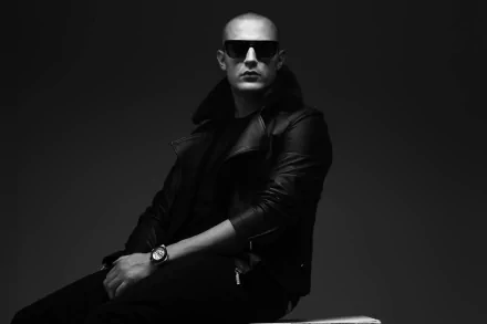 HD desktop wallpaper featuring a monochromatic portrait of a stylish man in sunglasses and a leather jacket, suitable as a background.