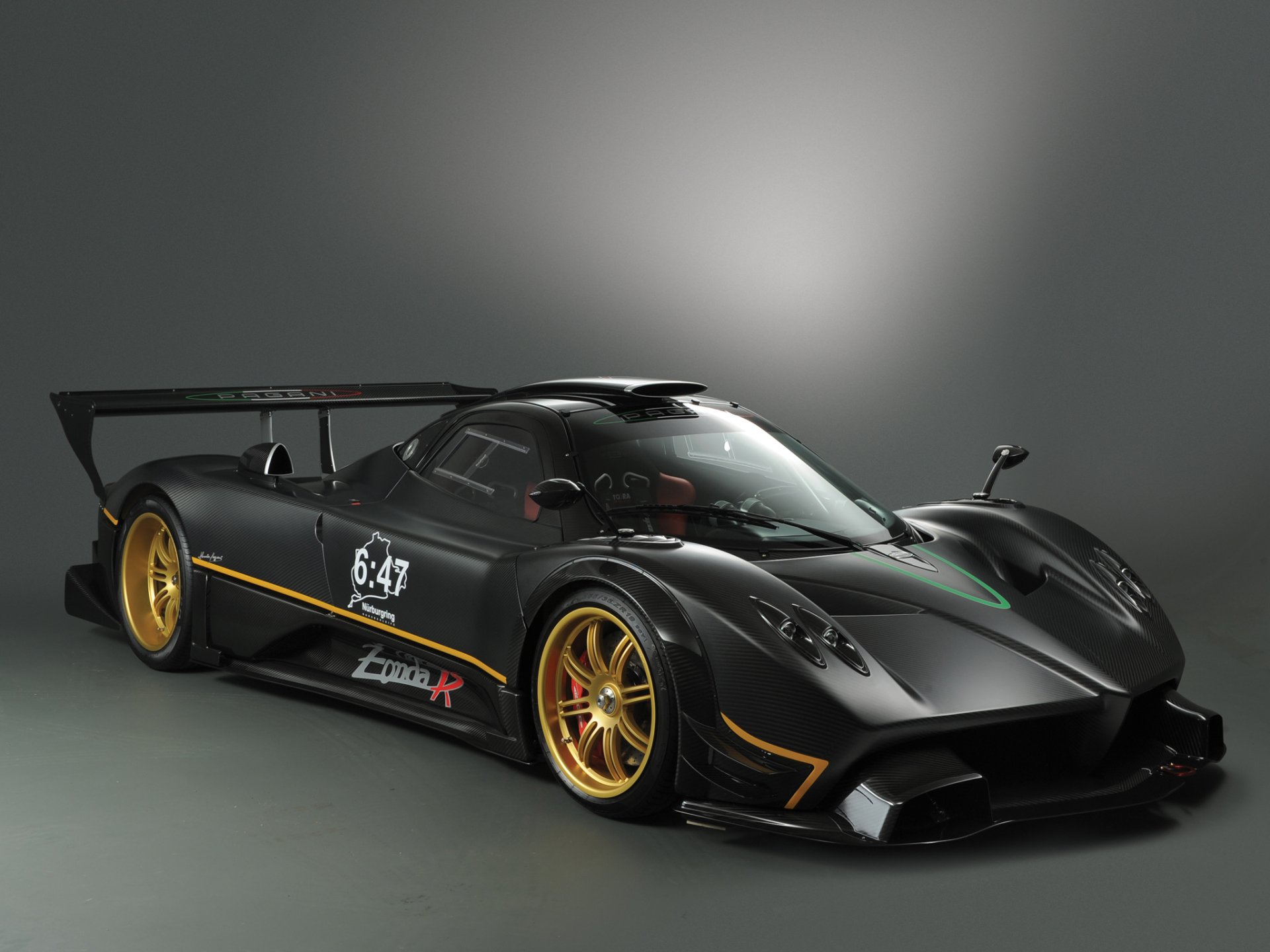 HD PC desktop wallpaper of a black Pagani Zonda R supercar — a Pagani Zonda performance car with gold wheels, large rear wing and racing accents, photographed as a high-performance vehicle.