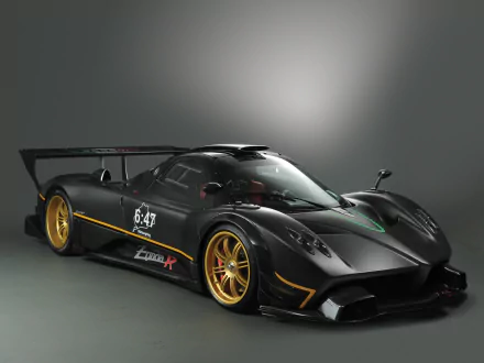 HD PC desktop wallpaper of a black Pagani Zonda R supercar — a Pagani Zonda performance car with gold wheels, large rear wing and racing accents, photographed as a high-performance vehicle.