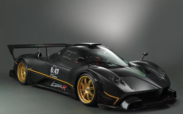HD PC desktop wallpaper of a black Pagani Zonda R supercar — a Pagani Zonda performance car with gold wheels, large rear wing and racing accents, photographed as a high-performance vehicle.