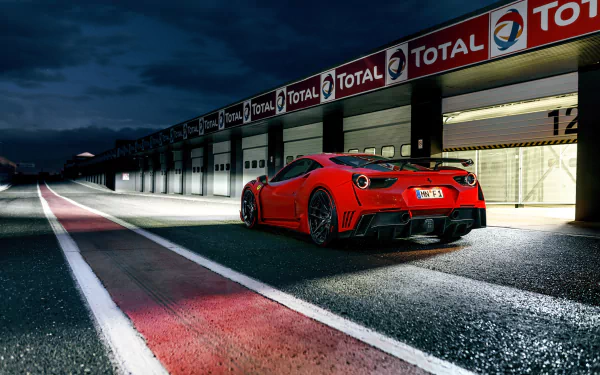 Red Ferrari 488 GTB supercar parked by a racing pit lane at night, captured in 4K Ultra HD for a stunning PC desktop wallpaper background.