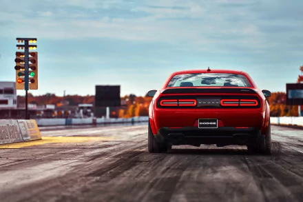 Rear view of a red Dodge Challenger SRT Demon muscle car on a drag strip under a clear sky, featured as an HD PC desktop wallpaper and background.