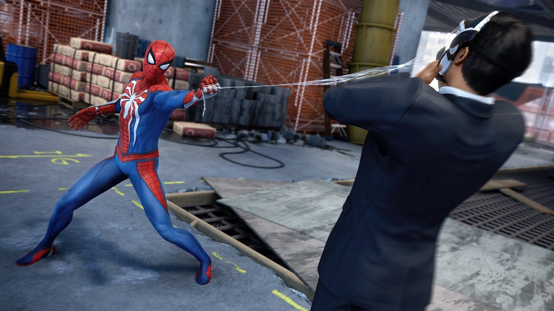 Spider-Man in action from the Spider-Man (PS4) video game. He is shown using his web to subdue a suited enemy in an industrial setting. HD desktop wallpaper and background.