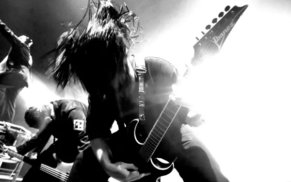 Black and white HD wallpaper of a heavy metal guitarist from Slipknot, capturing intense energy in an industrial and nu metal music vibe.