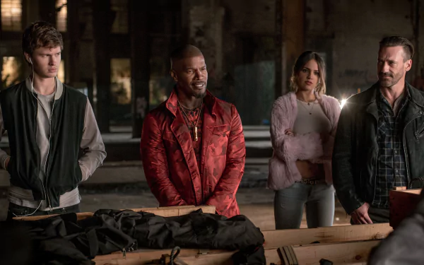 HD wallpaper featuring characters from Baby Driver, including actors Ansel Elgort, Jamie Foxx, Eiza Gonzalez, and Jon Hamm in a tense scene.