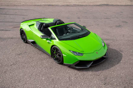 An HD desktop wallpaper featuring a vibrant green Lamborghini Huracan supercar parked on an asphalt surface, showcasing its sleek design and stylish appeal.