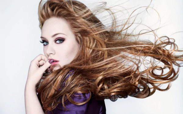 HD desktop wallpaper featuring British English singer Adele with flowing hair and intense gaze, embodying her iconic music presence.