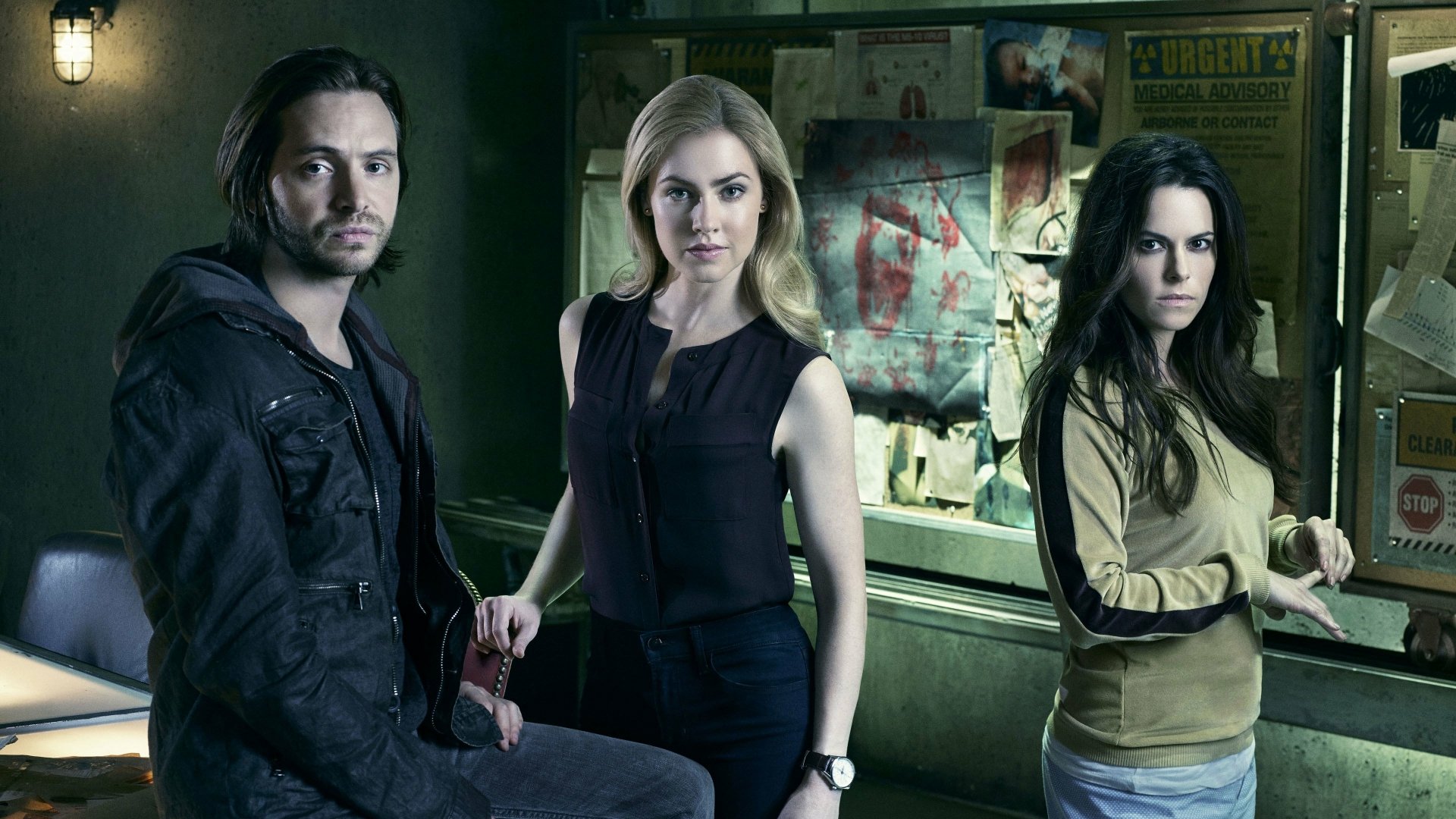 A 4K Ultra HD PC desktop wallpaper featuring three main characters from the TV show 12 Monkeys standing in a dimly lit room with a bulletin board in the background.