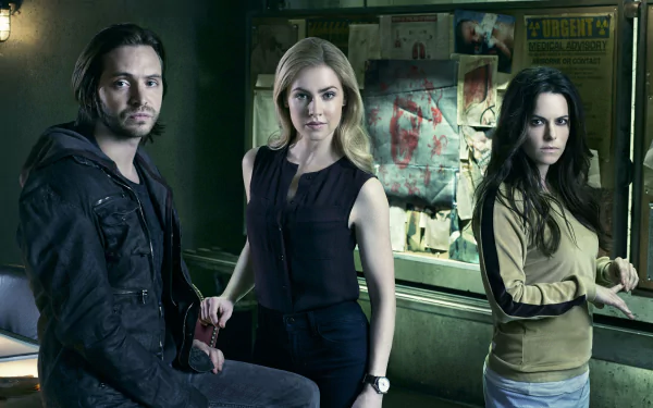 A 4K Ultra HD PC desktop wallpaper featuring three main characters from the TV show 12 Monkeys standing in a dimly lit room with a bulletin board in the background.