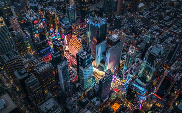 Aerial nighttime view of Manhattan’s Times Square in New York, showcasing illuminated skyscrapers and vibrant city lights in this HD USA desktop wallpaper.