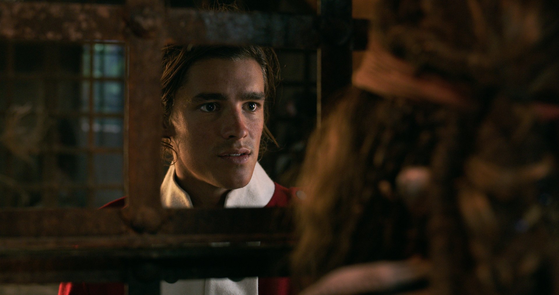 HD PC wallpaper: young man in 18th-century naval coat peers through prison bars at a robed figure, dramatic scene from Pirates of the Caribbean: Dead Men Tell No Tales.