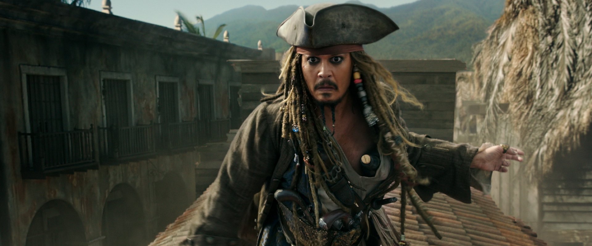 HD desktop wallpaper featuring Johnny Depp as Jack Sparrow from the movie Pirates of the Caribbean: Dead Men Tell No Tales in a dramatic, action-packed scene.