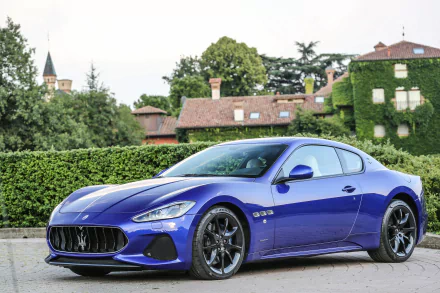 Blue Maserati GranTurismo grand tourer supercar car vehicle parked before hedges and an ivy-covered villa — 2K Quad HD PC desktop wallpaper background.