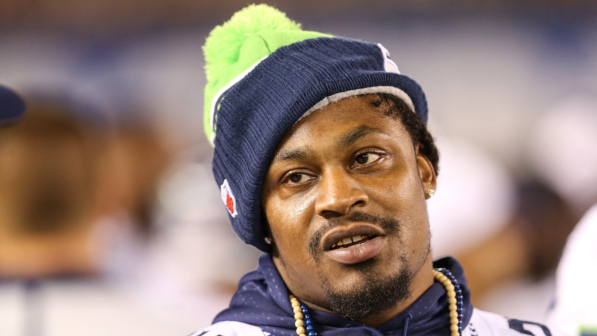 HD desktop wallpaper featuring Seattle Seahawks player Marshawn Lynch in team beanie.