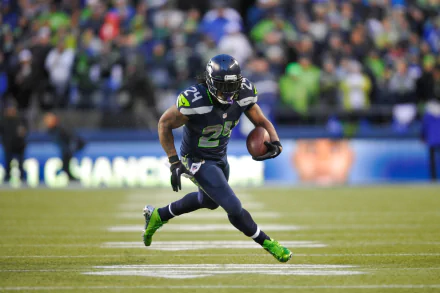 HD wallpaper of Seattle Seahawks player Marshawn Lynch in action on the football field.