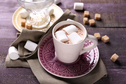 A 4K Ultra HD still life of a cup of hot chocolate topped with marshmallows, surrounded by sugar cubes on a rustic wooden surface.