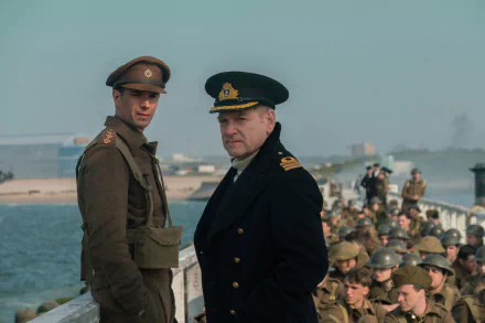 A HD desktop wallpaper featuring James D'Arcy and Kenneth Branagh from the movie Dunkirk. The scene captures the two characters in military uniform with soldiers in the background.